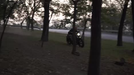 Brutal-guy-rides-a-motorcycle-cross-country-between-trees