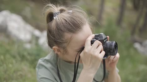 Slim-professional-caucasian-woman-photographing-nature-on-in-the-natural-park