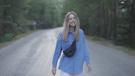 Happy-woman-walking-road-in-forest,-excited,-emotional