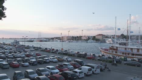 Zadar,-Croatia-car-park-and-port-on-summer-evening-with-pedestrians-and-ships