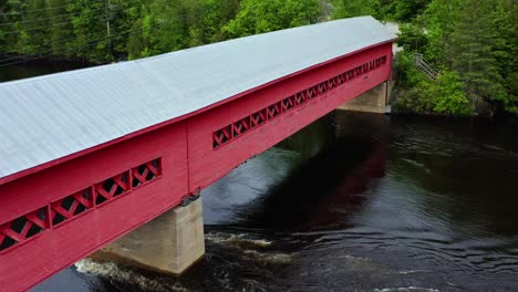 Close-up-drone-shot-of-a-well-preserved-historical-covered-bridge-located-in-Wakefield-Quebec-Canada
