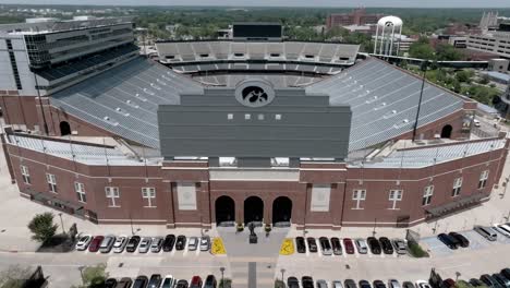 Kinnick-stadium-on-the-campus-of-the-University-of-Iowa,-home-of-the-Iowa-Hawkeyes-in-Iowa-City,-Iowa-with-drone-video-moving-back-and-up-parallax
