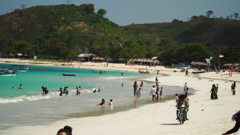 People-play-and-enjoy-sunny-day-at-paradise-Tanjung-Aan-beach,-Lombok,-Indonesia