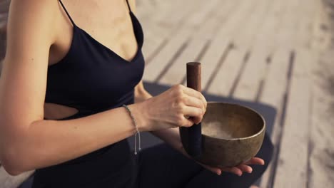 Unrecognizable-woman-with-tibetan-singing-bowl-for-yoga-and-meditation