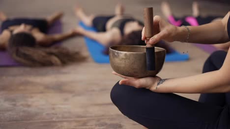 Singing-bowls-during-meditation,-lead-yoga-class-outdoors