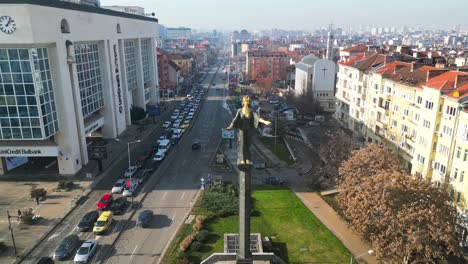 Aerial-view-of-UniCredit-Bulbank-building,-Saint-Sofia-Statue-at-Sofia-Square,-Traffic-across-the-streets-of-Sofia