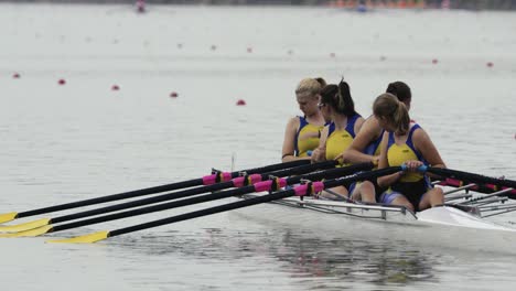 Women-in-jerseys-sitting-in-the-quad-scull-chatting-before-the-race