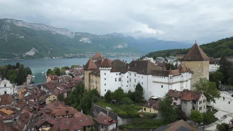 Medieval-Castle-in-Beautiful-Old-Town,-Annecy---Tourism-Travel-Destination-in-France,-Establishing-Aerial-Landscape