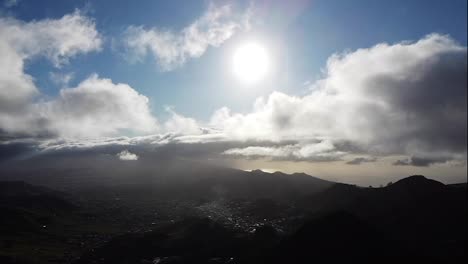 Aerial-footage-through-the-clouds-above-green-hills.-High-peaks-wonderful-morning-sunrise-natural-landscape,-above-ocean