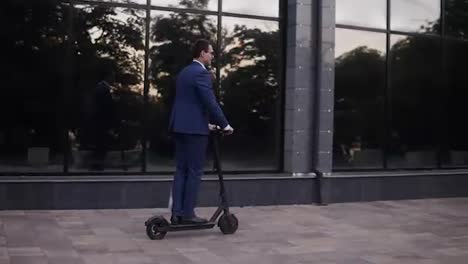 Young-businessman-riding-and-electric-scooter-for-a-business-meeting-in-the-office,-office-buildings,-businessman,-electric