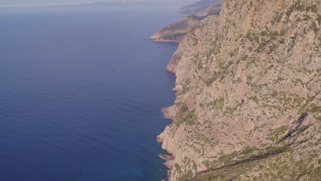 Reveal-shot-of-amazing-coastline-with-high-cliffs-at-Mallorca-Spain,-aerial