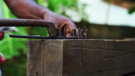 close-up-of-carpenter-using-manual-tools-for-bending-metal-in-construction-site