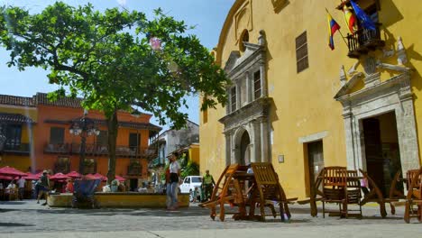 People-walk-past-closed-cafe-in-Cartagena