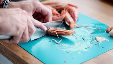 Chef-carefully-removing-a-Shrimp-Head-Preparing-Prawns-to-Be-Cooked-with-Pasta