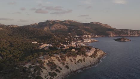 Wide-shot-of-Sant-Elm-village-at-Mallorca-during-sunset,-aerial