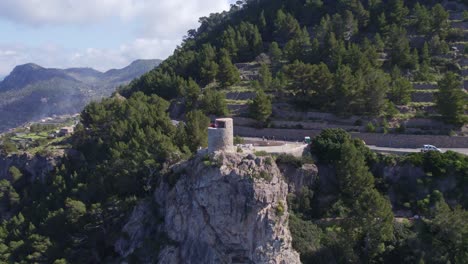 Flying-backward-at-Torre-de-Verger-Mallorca-during-day-time,-aerial