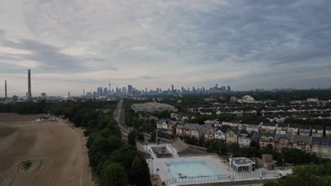 Cloudy-Sky-Over-Suburban-Neighborhood-With-Distant-View-Of-Toronto-Skyline-In-Background