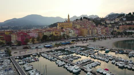Breathtaking-Colorful-Buildings-on-Coast-of-Menton-City,-France-at-Sunset---Aerial-Drone-Landscape