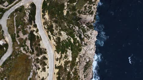 cliff-rocky-shoreline-topview-aerial-topshot,-abyss-canyon-sea-water-overview,-sand,-green-vegetation,-plants,-road,-car