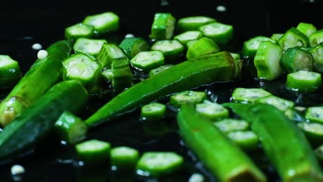Drops-of-water-falling-on-okra,-or-lady's-fingers-on-a-wet-surface