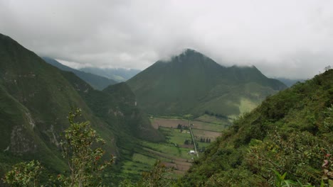 Valle-Debajo-De-Altas-Colinas-Verdes-De-Ecuador-Con-Cielo-Nublado