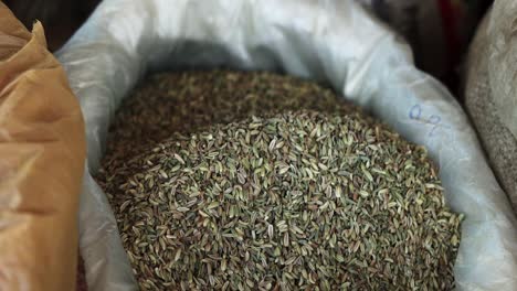 cumin-seeds-close-up-with-black-hand-,-organic-fresh-natural-healthy-food