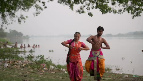 Two-dancers-dancing-Indian-classical-dance-bharatnatyam-Beautiful-indian-girl-and-boy-dancing,-slow-motion