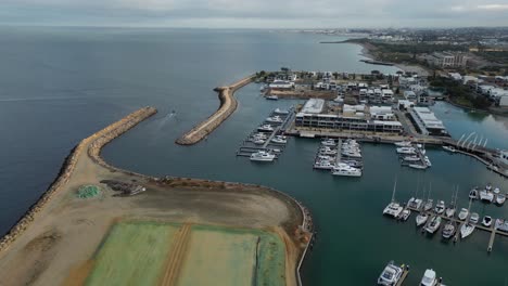 Flying-Over-Lot-Of-Boats-Side-By-Side-Anchored-At-Coogee-Port,-Perth-City