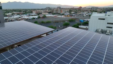 Solar-panels-above-parking-garage-with-mountains-and-sunset-in-distance