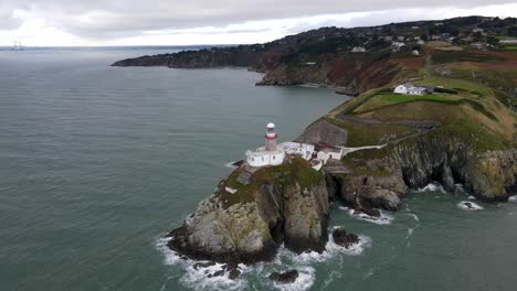 Drone-shot-of-a-small-lighthouse-on-a-cliff-near-Dublin
