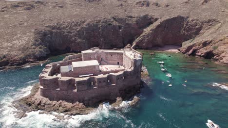 Low-angle-aerial-orbit-of-fort-of-the-berlengas,-above-turquoise-water