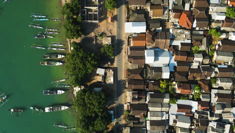 Aerial-View-of-Village-in-Southeast-Asia-with-Traditional-Fishing-Boats-and-Dense-Housing