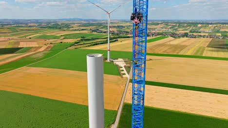Wind-Turbine-Tower-Under-Construction-In-Austria---aerial-drone-shot