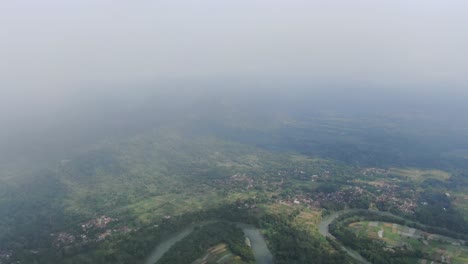 Foggy-day-over-landscape-of-Indonesia,-aerial-drone-view