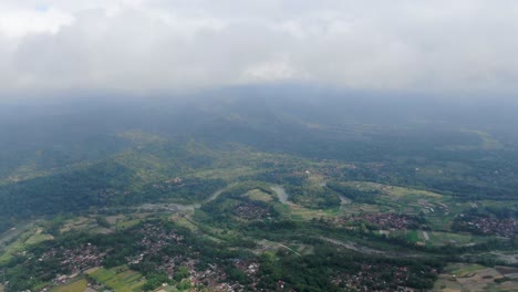 Vast-terrain-with-fields,-forests-and-villages-in-Indonesia,-aerial-drone-view