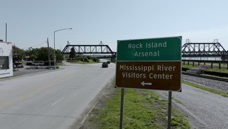 Rock-Island-Arsenal-sign-and-Mississippi-River-Visitors-Center-sign-in-Davenport,-Iowa-with-drone-video-stable