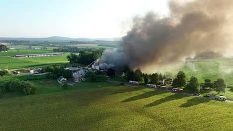 Wide-aerial-view-of-ongoing-fire-from-gas-explosion,-emergency-services-at-work,-usa