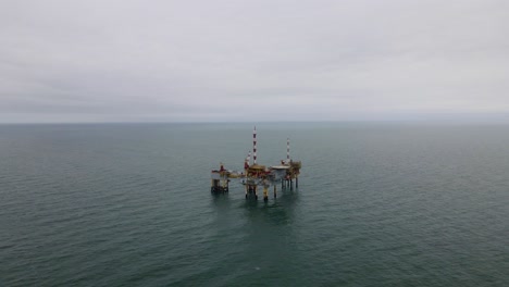 Drone-shot-of-a-oil-rig-near-the-coast-of-Ameland,-The-Netherlands