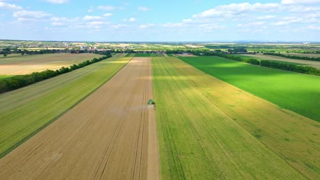 Combine-Harvesting-Wheat-In-Summer---drone-shot