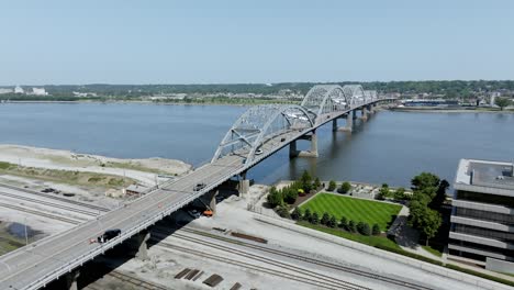 Bridge-over-Mississippi-River-in-Davenport,-Iowa-with-cars-driving-over-it-and-drone-video-stable