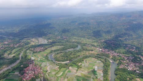 Towns-situated-near-river-water-in-Indonesia,-aerial-drone-view