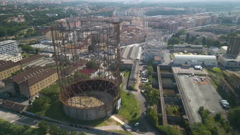 Aerial-drone-panning-shot-over-Gasometro-or-Gazometro-in-Ostiense-district-of-Rome,-Italy-at-daytime