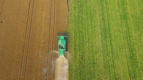 Combine-Harvester-Working-On-A-Land-Of-Hay---aerial-top-down