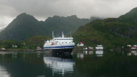 Car-Ferry-Approaching-the-Dock-in-the-Lofoten-Islands-on-a-Cloudy-Summer-Day,-Moskenes,-Norway