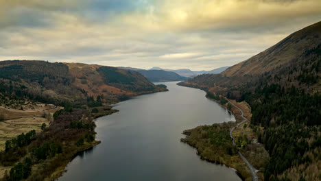 Behold-the-mysterious-and-dramatic-beauty-of-the-Cumbrian-countryside-through-mesmerizing-drone-footage,-capturing-Thirlmere-Lake-and-the-majestic-mountains-that-envelop-it
