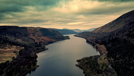 Experience-the-stunning-beauty-of-Cumbria-through-a-mesmerizing-aerial-video,-capturing-Thirlmere-Lake-encircled-by-grand-mountains