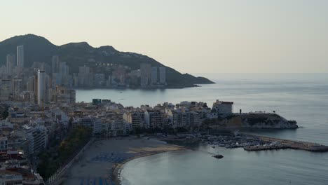 Mediterranean-early-morning-Benidorm-beach-and-coastline-from-above-4K