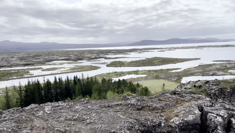 Iceland---Experience-the-unique-allure-of-Thingvellir-National-Park,-where-jagged-lava-fields-and-crystal-clear-lakes-create-a-mesmerizing-backdrop