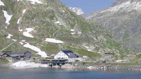 Mountain-resort-next-to-Alpine-Lake,-in-Switzerland