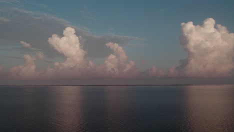 Static-aerial-shot-of-beautiful-calm-bay-with-tall-storm-clouds-looming-over